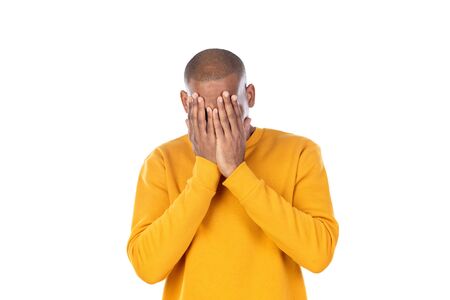 Afroamerican guy wearing a yellow jersey isolated on a white backgroundの写真素材