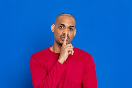 African guy with red jersey on a blue background