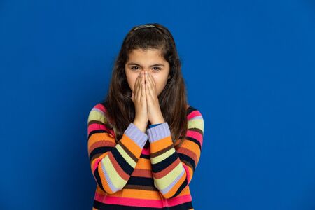 Adorable preteen girl with striped jersey on a blue background