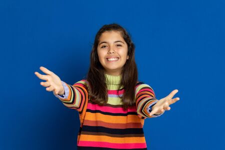 Adorable preteen girl with striped jersey on a blue backgroundの写真素材