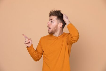 Attractive young guy on a yellow background