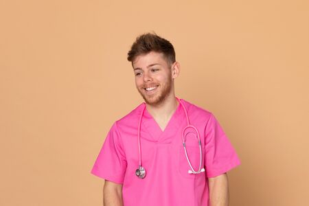 African doctor wearing a pink uniform on a yellow backgroundの写真素材