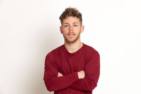 Attractive young guy with a red T-shirt isolated on a white background
