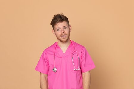African doctor wearing a pink uniform on a yellow backgroundの写真素材