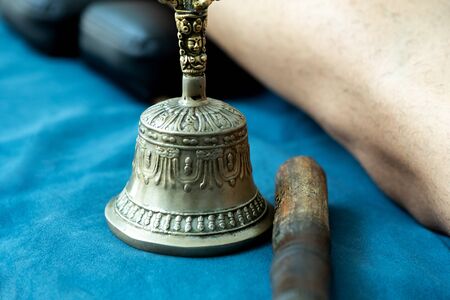 Instruments for a alternative therapy, a metal object like a bell and a stickの写真素材