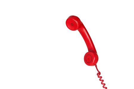 Red vintage phone hanging of a cable isolated on a white backgroundの写真素材