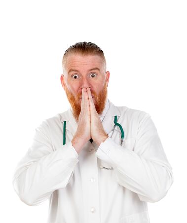 Surprised redhead doctor isolated on a white backgroundの写真素材