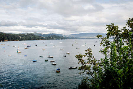 Beautiful views of the Spanish north coast with small boatsの写真素材