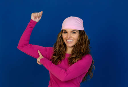 Hopeful woman wearing a pink scarf isolated on a white background