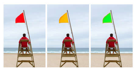 Three option in the beach. The lifeguard sitting with three different flagsの写真素材