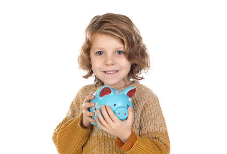 Cute child holding a blue moneybox isolated on a white backgroundの写真素材