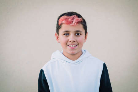 Teenager boy with hair painted red outdoorsの写真素材