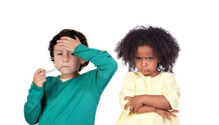 Litlle boy with fever and an angry girl looking at camera isolated on a white backgroundの写真素材