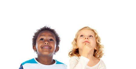 Two funny children looking up isolated on a white background