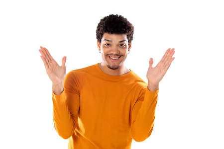 Smiling young man with afro hair wearing orange sweater isolated on a white background