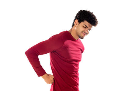 Cute african american man with afro hairstyle wearing a burgundy T-shirt isolated on a white...
