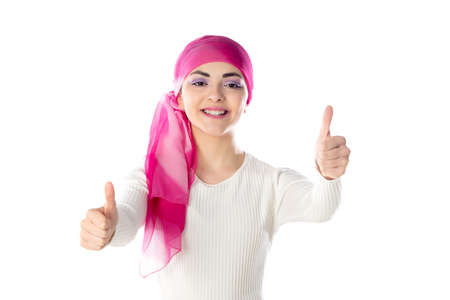 Young brunette woman wearing pink head scarf isolated on a white backgroundの写真素材