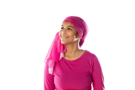Young beautiful African woman wearing pink headscarf isolated on a white backgroundの写真素材