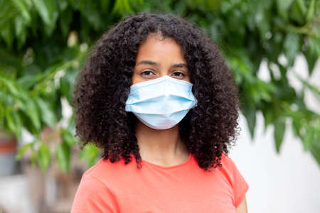 African teenager wearing a mask in order to protect hemself from the virusの写真素材