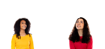 Teenager girls looking up isolated on a white background