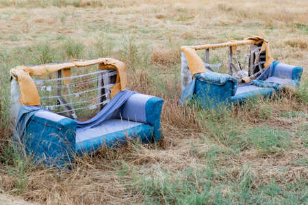 Old abandoned sofa in the forest. Abandoned places of the planet