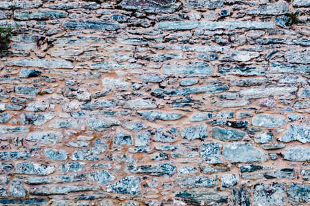 Old wall of stone rock of arbitrary shape.