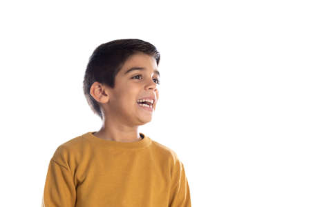 Pensive cute Spanish child with yellow t-shirt isolated on a white backgroundの写真素材