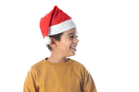 Portrait of a little child in red santa hat on white background