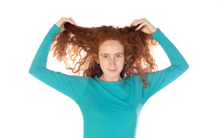 Pretty redhead young woman with long wavy hair and freckles wears t-shirt feels satisfied and looks confident isolated over white backgroundの写真素材
