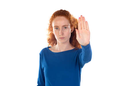 Redhead young woman wearing casual blue t shirt doing stop sing with palm of the hand. Warning...