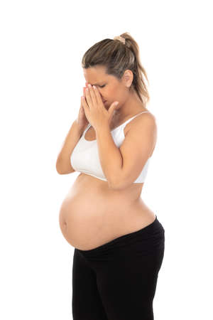 Discomfort during pregnancy. Pregnant woman isolated on a white backgroundの写真素材