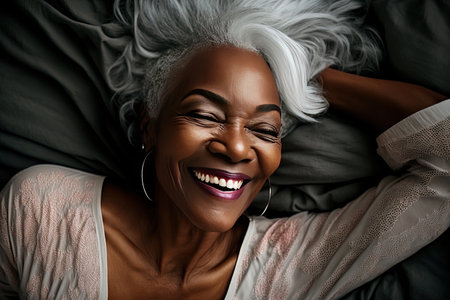 Sincere smile of an exultant mature woman with white hair waking up in bed. Generative AIの素材