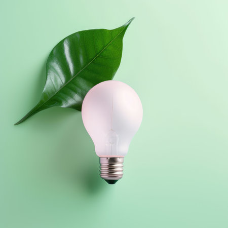 Renewable Energy and Sustainable Living concept depicted by a top view of an Eco-friendly lightbulb made of fresh leaves against a pastel colored backdrop by generative AIの素材