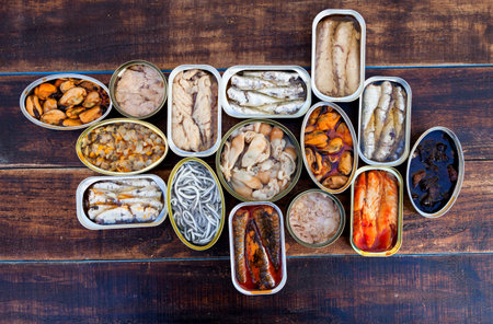 Assortment of open tin cans for a healthy dinnerの写真素材