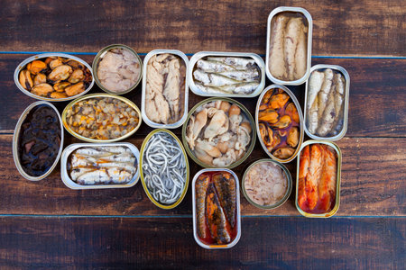 Assortment of open tin cans for a healthy dinnerの写真素材