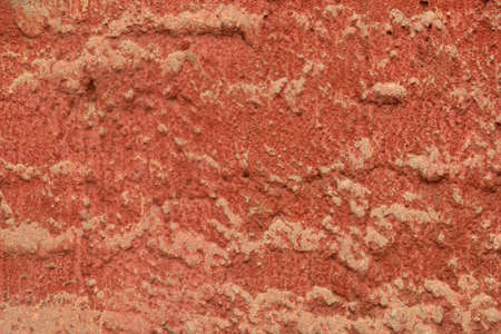 Abstract red-brown concrete background with embossed texture of plaster wall.
