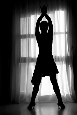 Latin dancer silhouette on a window.の写真素材