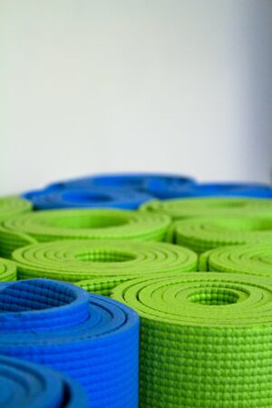 Shallow focus image of colorful, rolled up yoga mats.の写真素材
