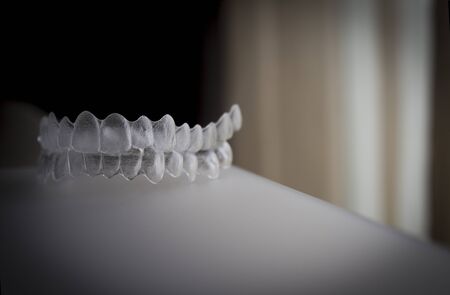 Isolated dental retainers in brown background.の写真素材