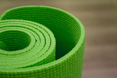 Green Shallow focus image of colorful, rolled up yoga mat.の写真素材