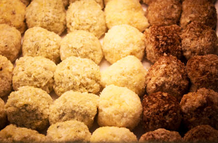 Not for vegetarians: Meatballs before cooking or frying, arranged on baking paper.