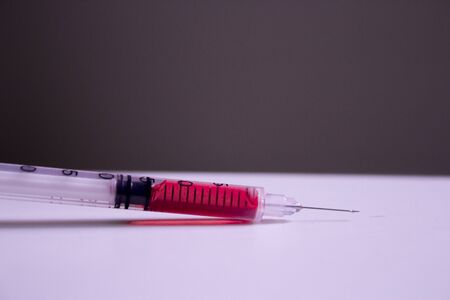A syringe filled with blood.の写真素材