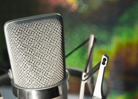 Silver microphone on colorful background in studio.の写真素材
