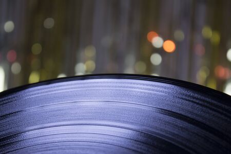 Part of a vinyl on background of defocused lights.の写真素材