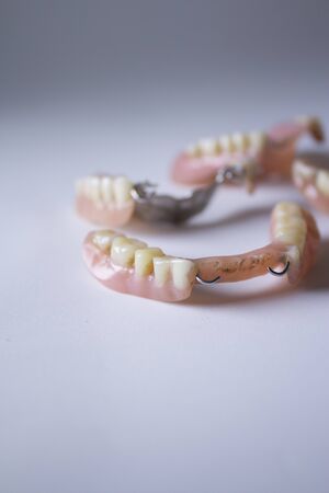 Lower dentures with braces on a white background.