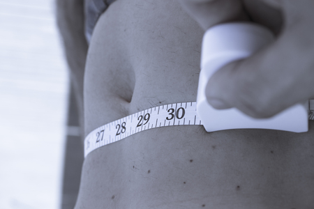 Body of a man measuring contour and body fatの写真素材