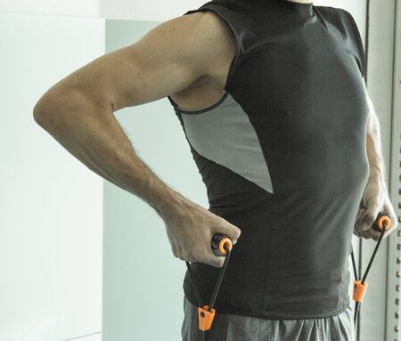 Performing exercises with resistance rope fitnessの写真素材