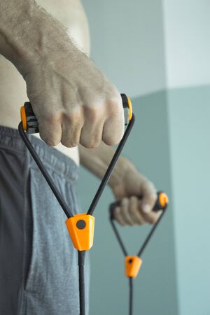 Performing exercises with resistance rope fitnessの写真素材