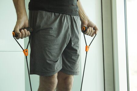 Performing exercises with resistance rope fitnessの写真素材