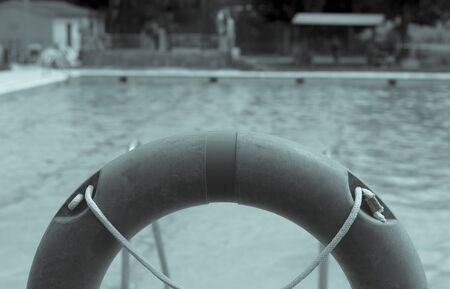 Orange life float. View of pool in the background unfocused.の写真素材